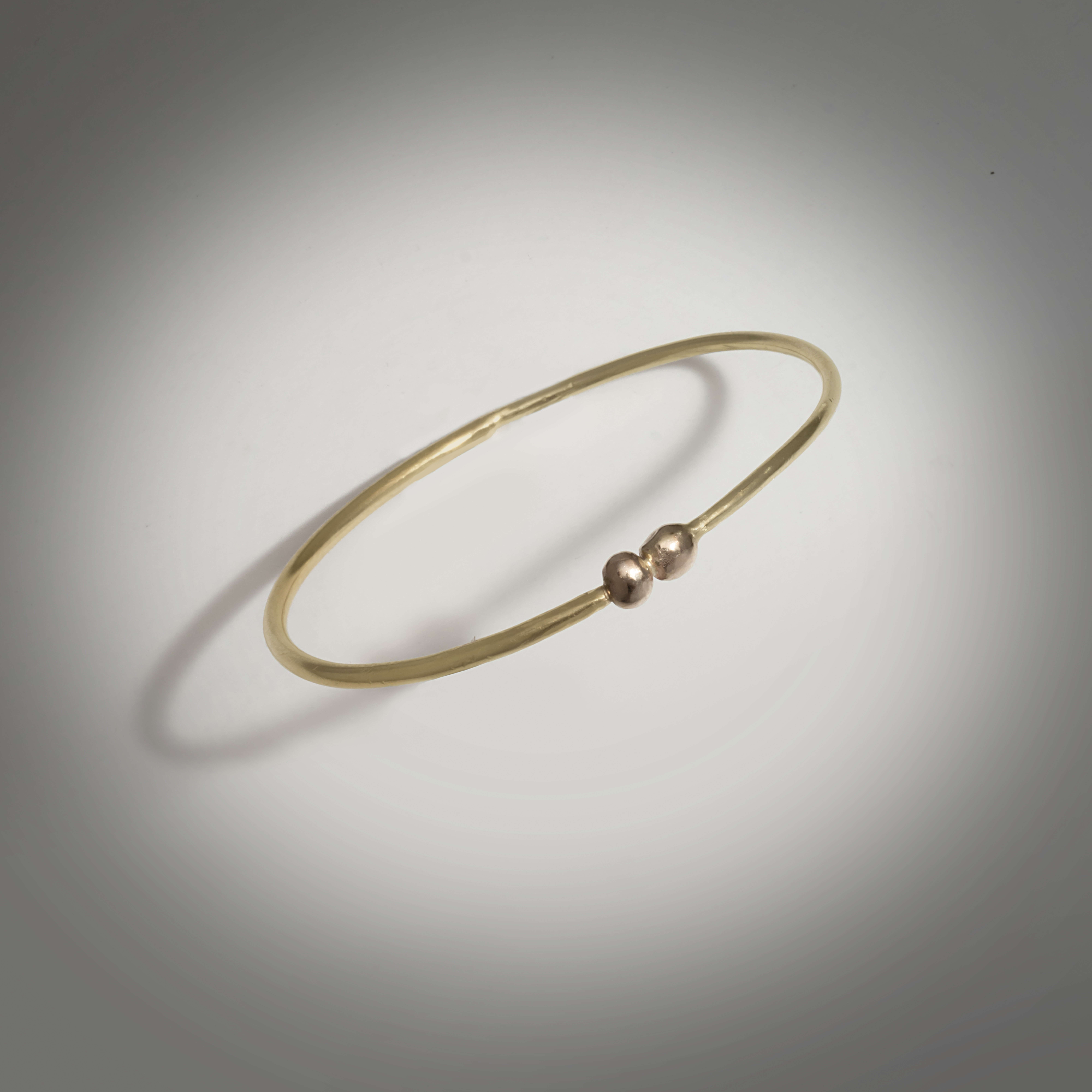 Circle Bangle bracelet with pebble detail, 18k Yellow gold